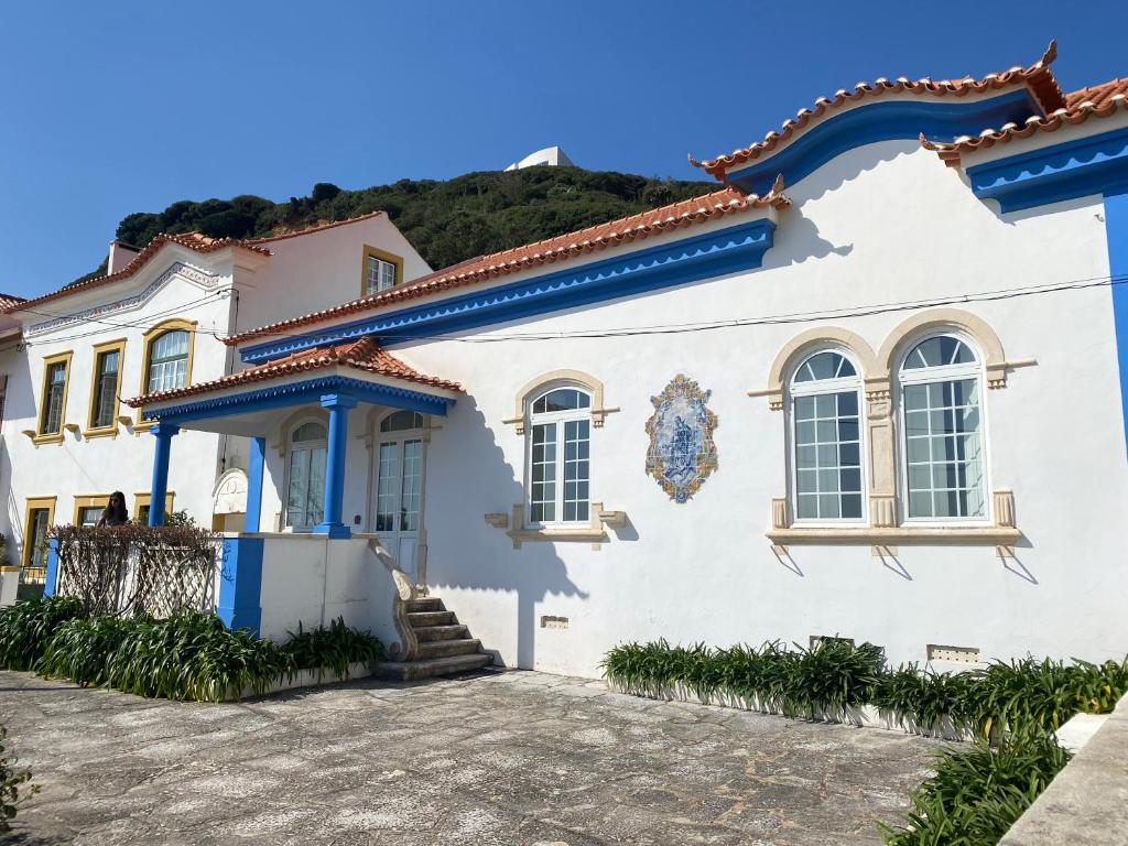 a white house with blue trim at Casa Azul do Cais in São Martinho do Porto