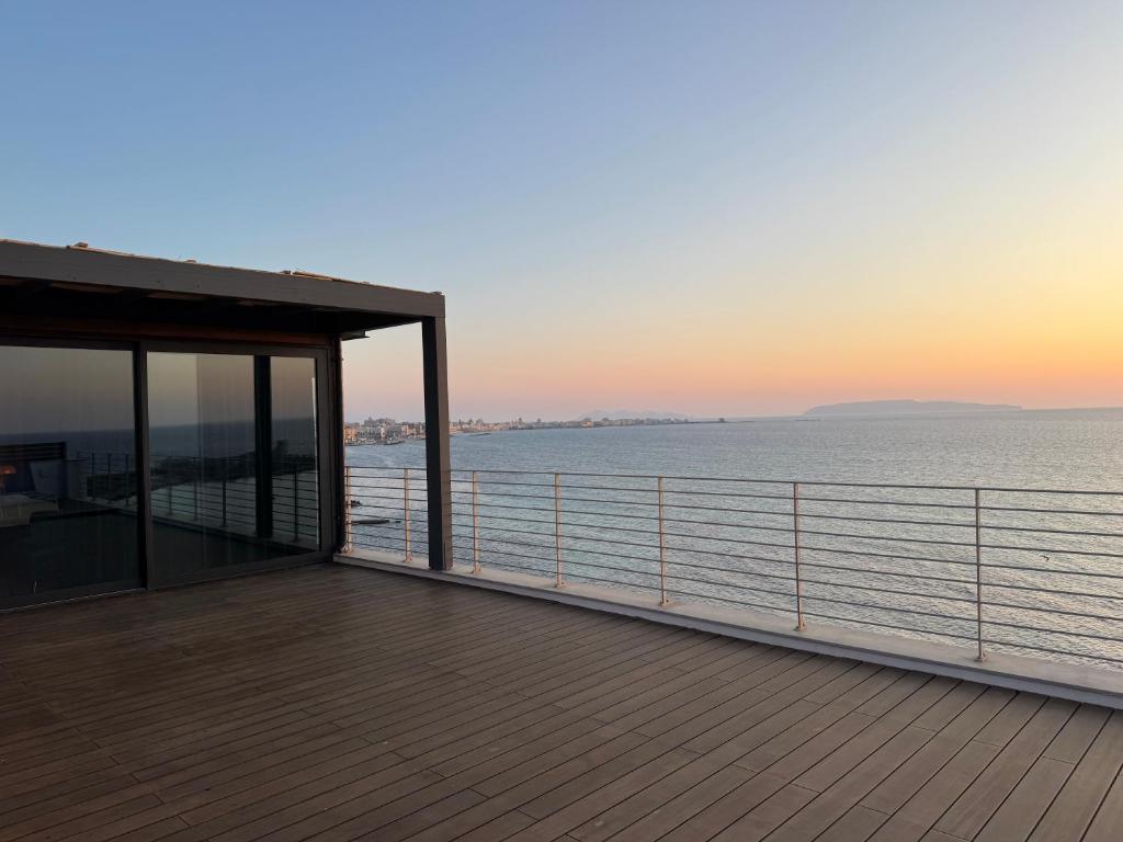 a view of the ocean from the deck of a house at Hotel Punta Tipa in Trapani