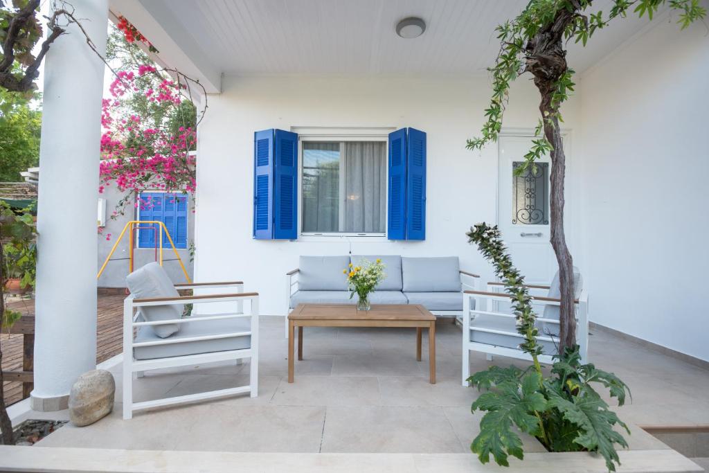 a patio with a couch and chairs and a table at Velanidia House in Lygia