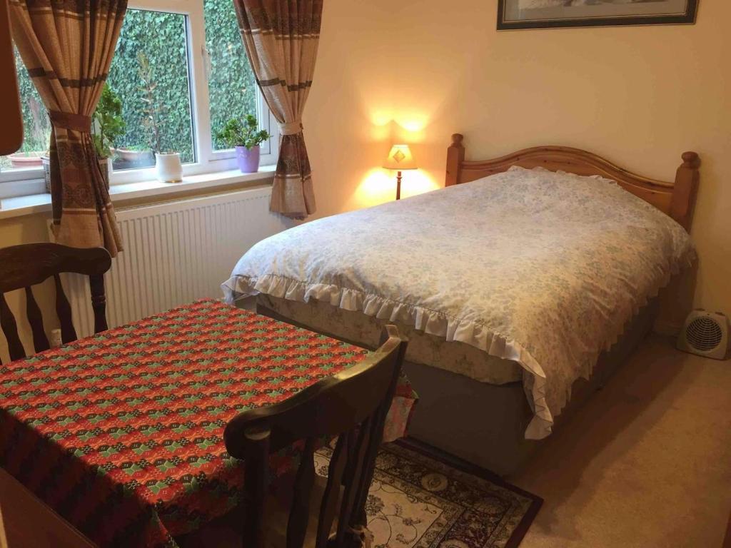 a bedroom with a bed and a table and a chair at Cowley, Oxford House in Oxford