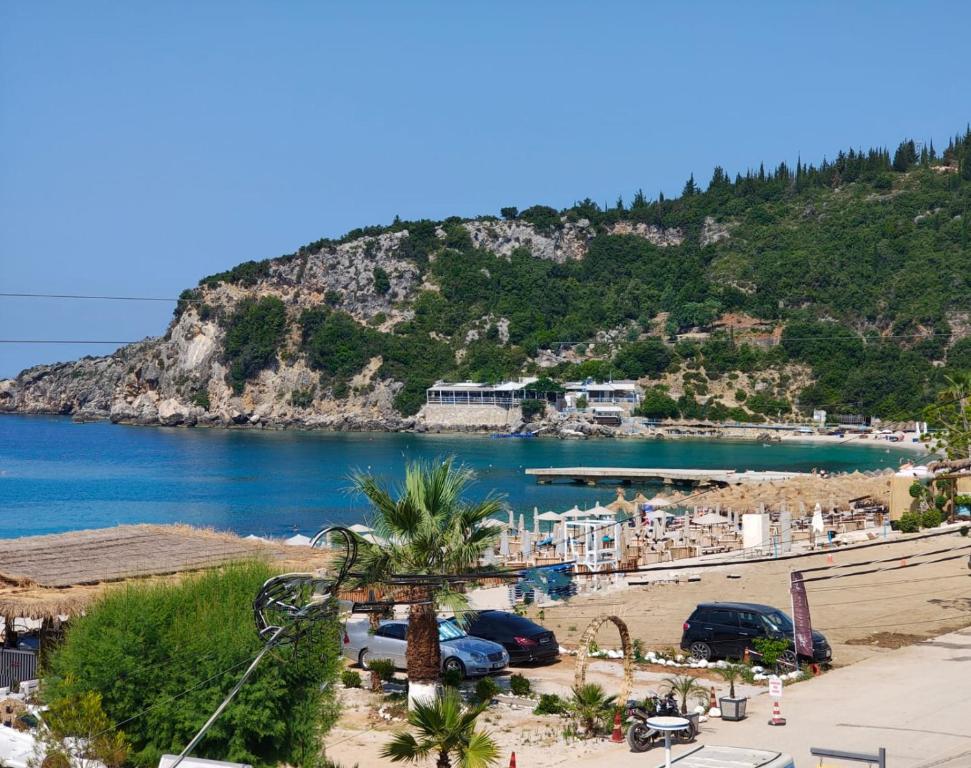 a view of a beach with a mountain in the background at Anxhelos Hotel in Himare