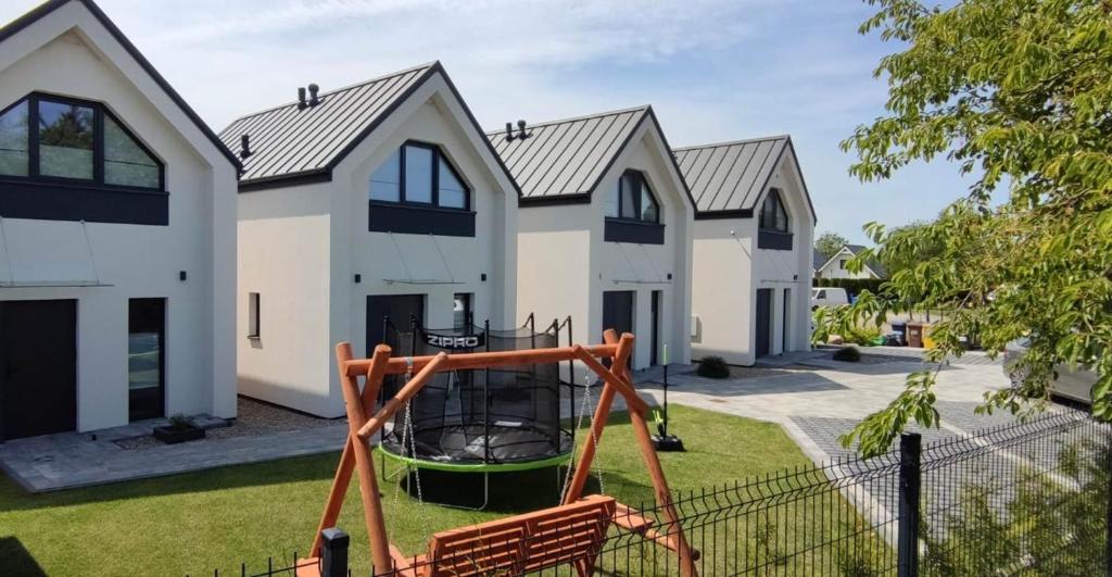 a house with a playground in front of it at Sorella House in Sianozety