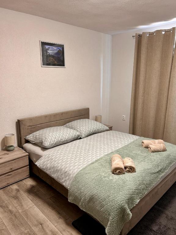 a bedroom with a bed with two towels on it at Apartmán u zajaca v Liptovskom Trnovci in Liptovský Trnovec