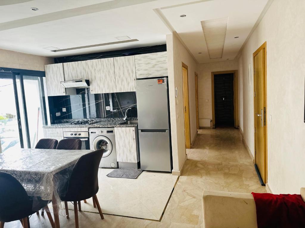 a kitchen and dining room with a table and chairs at Appartement vu sur mer in Pont Blondin