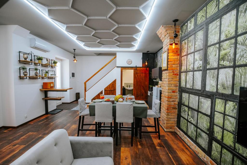 a dining room with a table and chairs at The Loft Esztergom - Központi privát ház, wellness in Esztergom