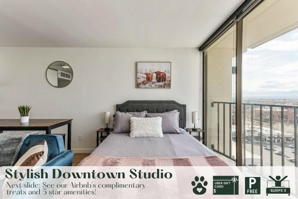 a bedroom with a bed and a balcony at Stylish Downtown Studio Conference Rooms Free Pkg Gym in Salt Lake City