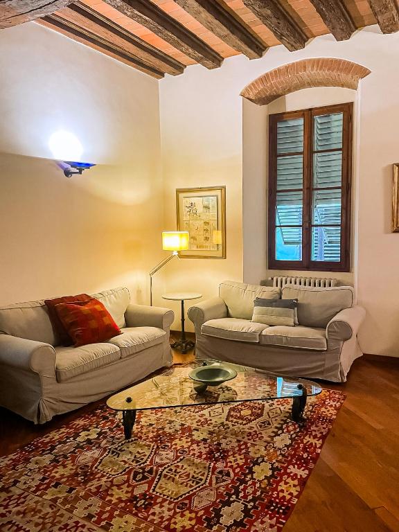 a living room with two couches and a coffee table at Acacia Firenze - Quercia in Florence