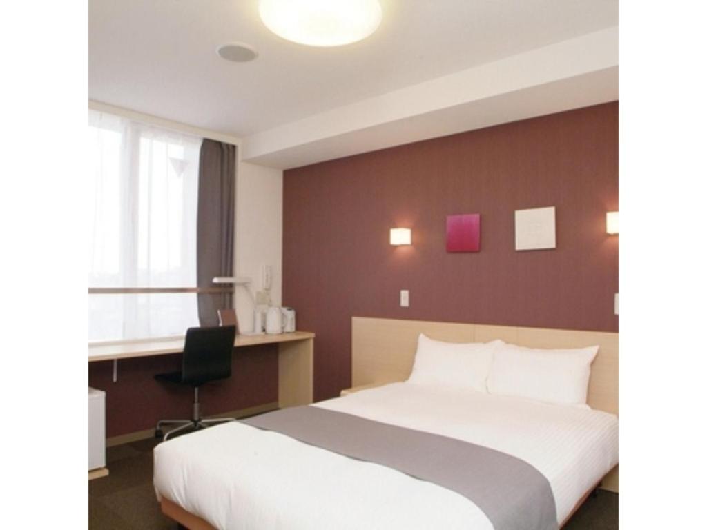a hotel room with a bed and a desk at Quad Inn Yokote - Vacation STAY 57392v in Yokote