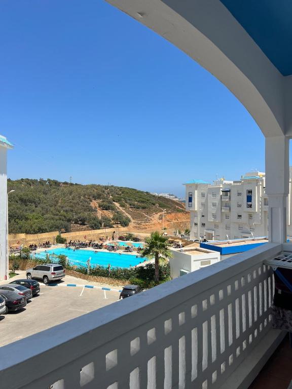 a balcony with a view of a parking lot at Apartment with pool near beach in Fnidek