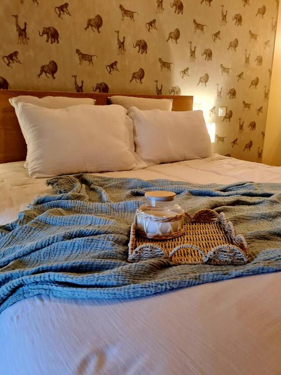 a bed with a tray of food on it at La Hulottière in Saint-Rémy-du-Plein