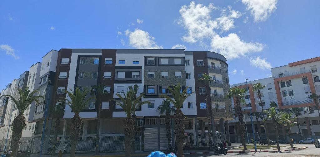 a building with palm trees in front of it at El jadida in El Jadida
