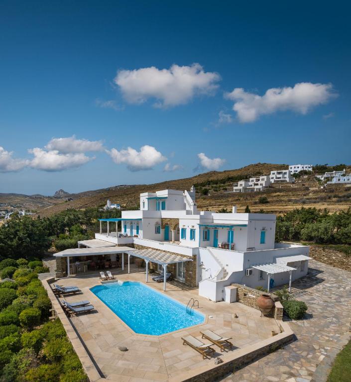 an aerial view of a house with a swimming pool at Villa Marble Tinos in Agios Fokas