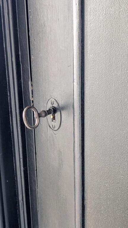 a door with a key in the middle of it at Kasarminkadun Basic Cozy 19,5 m2 in Vaasa