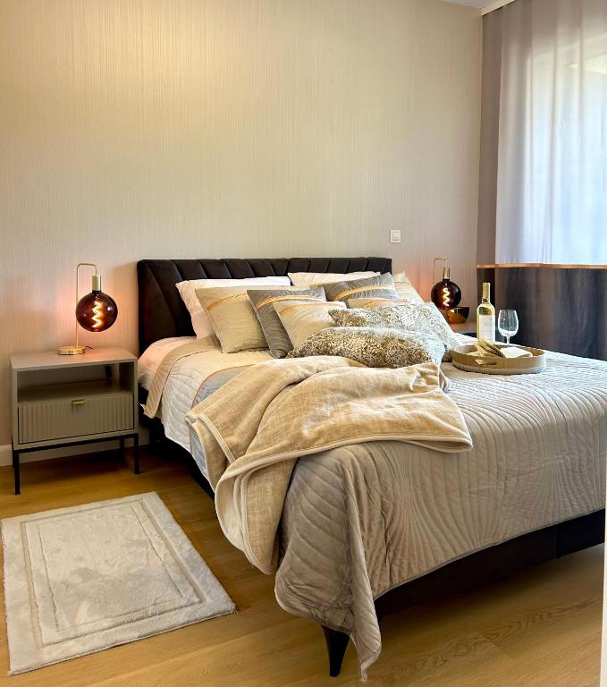 a bedroom with a large bed and a window at Augustów apartament nad jeziorem in Augustów