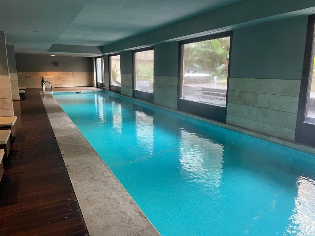 a swimming pool with blue water in a building at Loft Full Amenities en Retiro in Buenos Aires