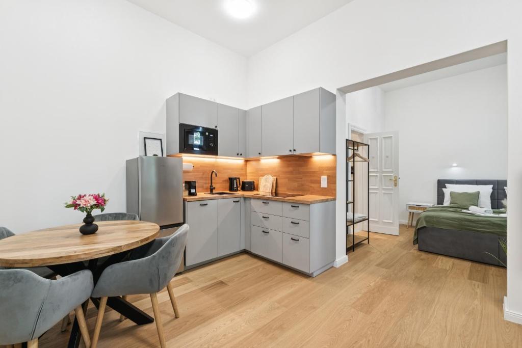 a kitchen and dining room with a table and a bed at Modern Apartment in Berlin in Berlin
