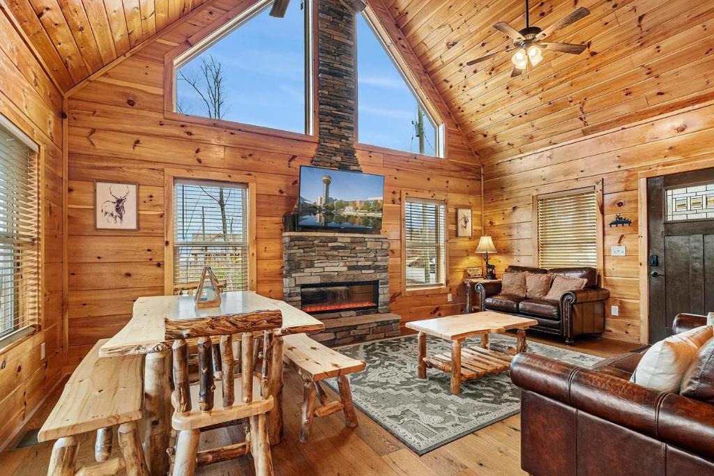 a log cabin living room with a fireplace at Hickory Haven By Avada Properties in Gatlinburg
