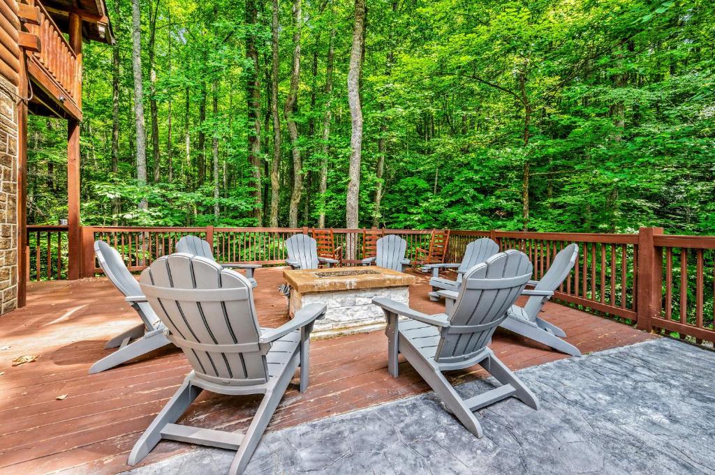 Forest Creek Retreat By Avada Properties في سيفيرفيل: مجموعة من الكراسي تجلس على سطح مع الأشجار