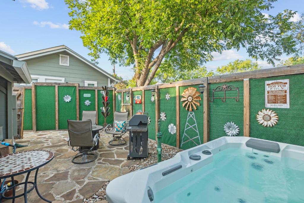 a backyard with a hot tub and a fence at 1929 Wash House in Fredericksburg