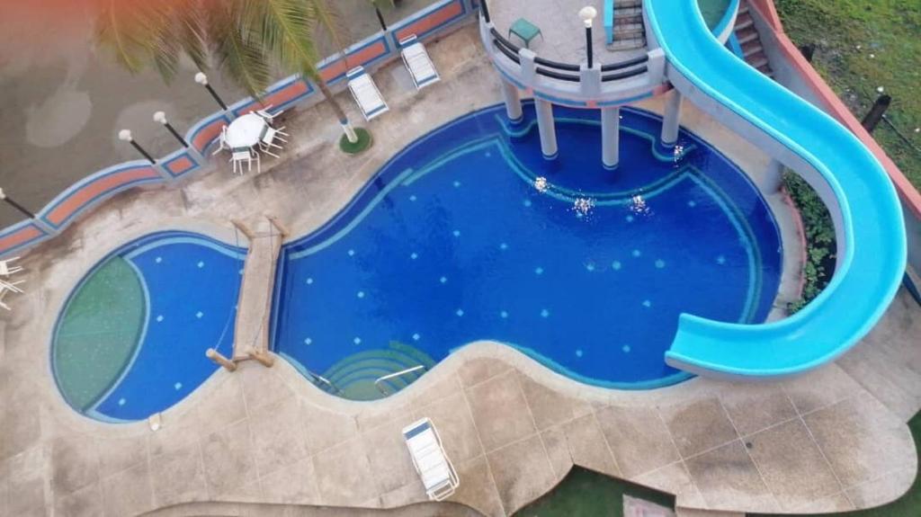 an overhead view of a swimming pool with a water slide at Oceanfront apartment in Morrocoy, Tucacas, PB in Tucacas