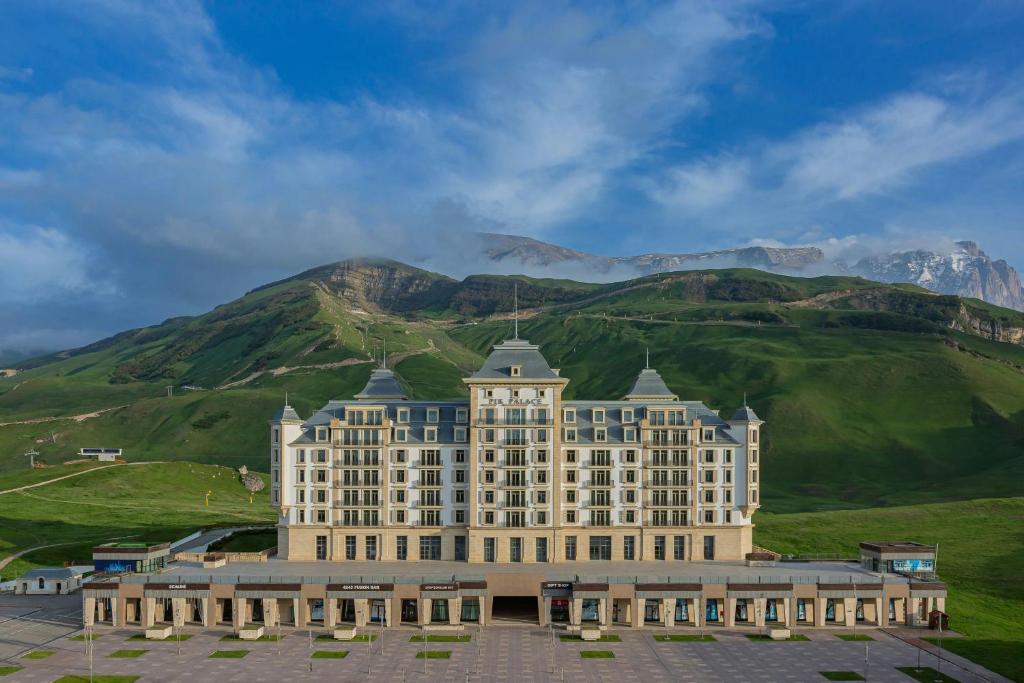 a large building in front of a mountain at Pik Palace, Shahdag, Autograph Collection in Shahdag