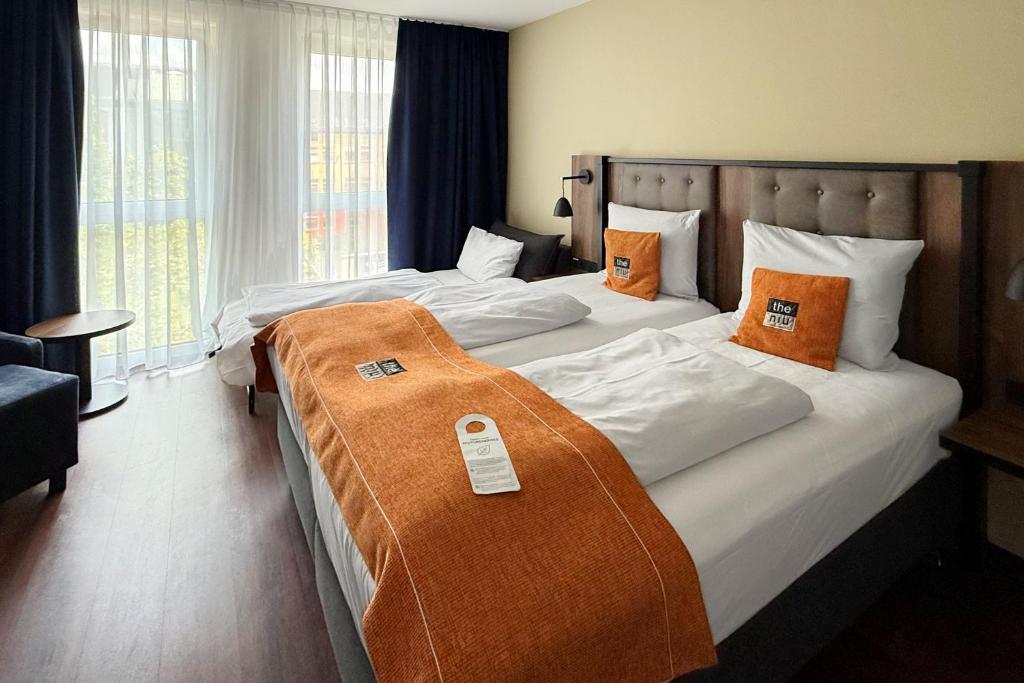 Postel nebo postele na pokoji v ubytování Holiday Inn - the niu, Saddle Fürth by IHG