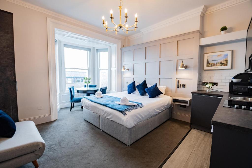 a bedroom with a bed and a table and a kitchen at Studio with Scenic Marina Views in Dublin