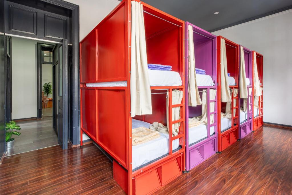 a red bunk room with a row of bunk beds at Hostel Bemaro Mexico City in Mexico City