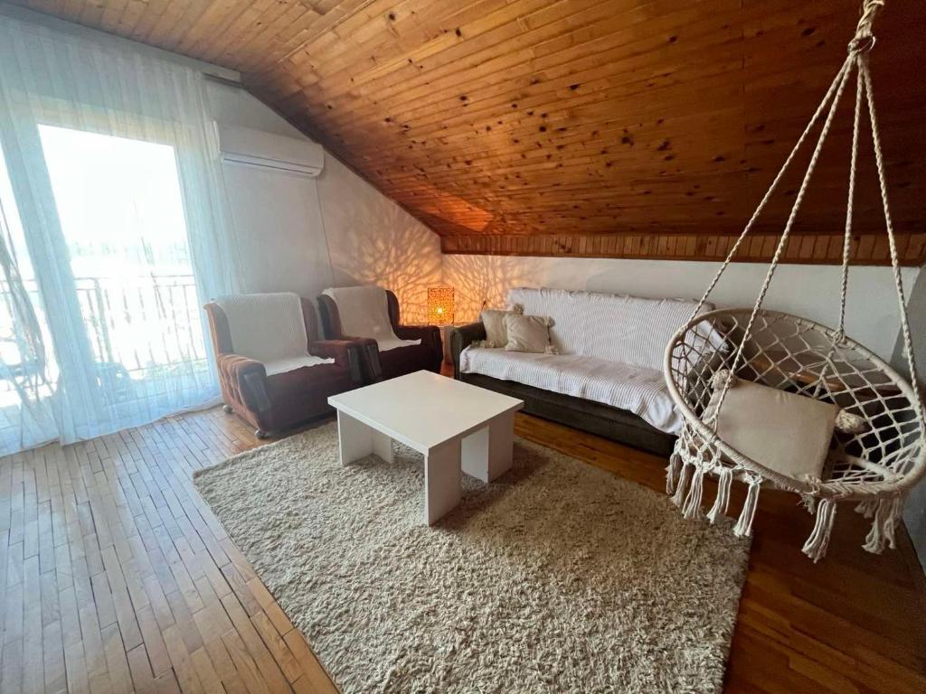 a living room with a hammock and a swing at Apartman Vana in Vrnjačka Banja