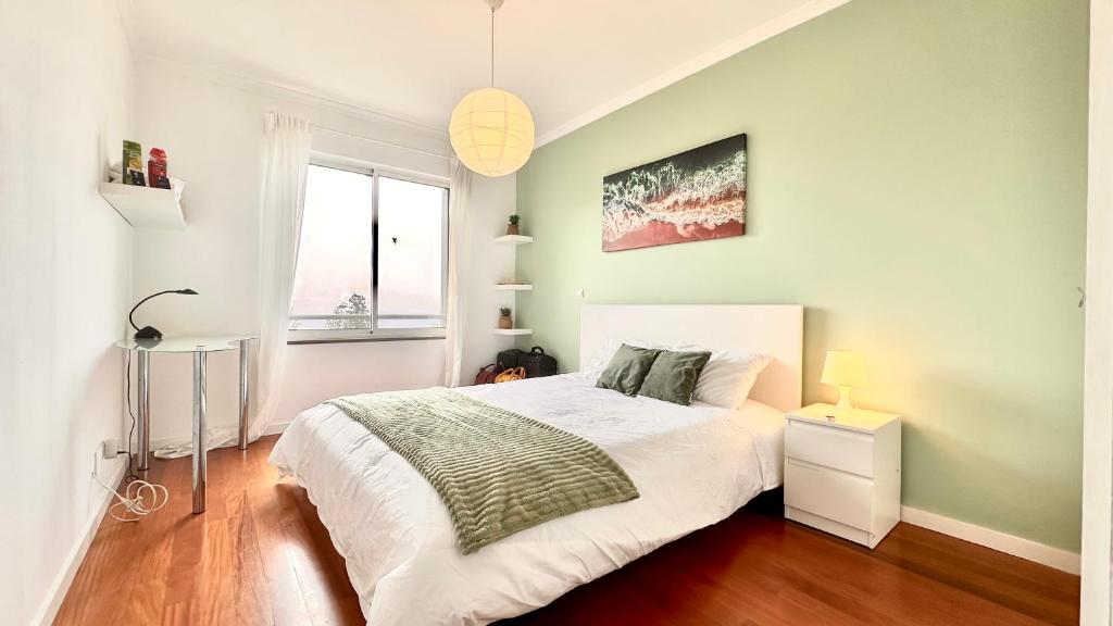 a bedroom with a large bed and a window at Edna 2 in Funchal