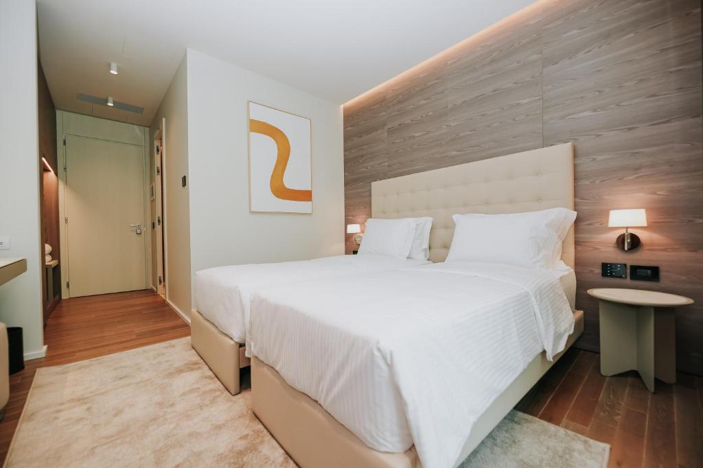 Postel nebo postele na pokoji v ubytování Magnus Hotel