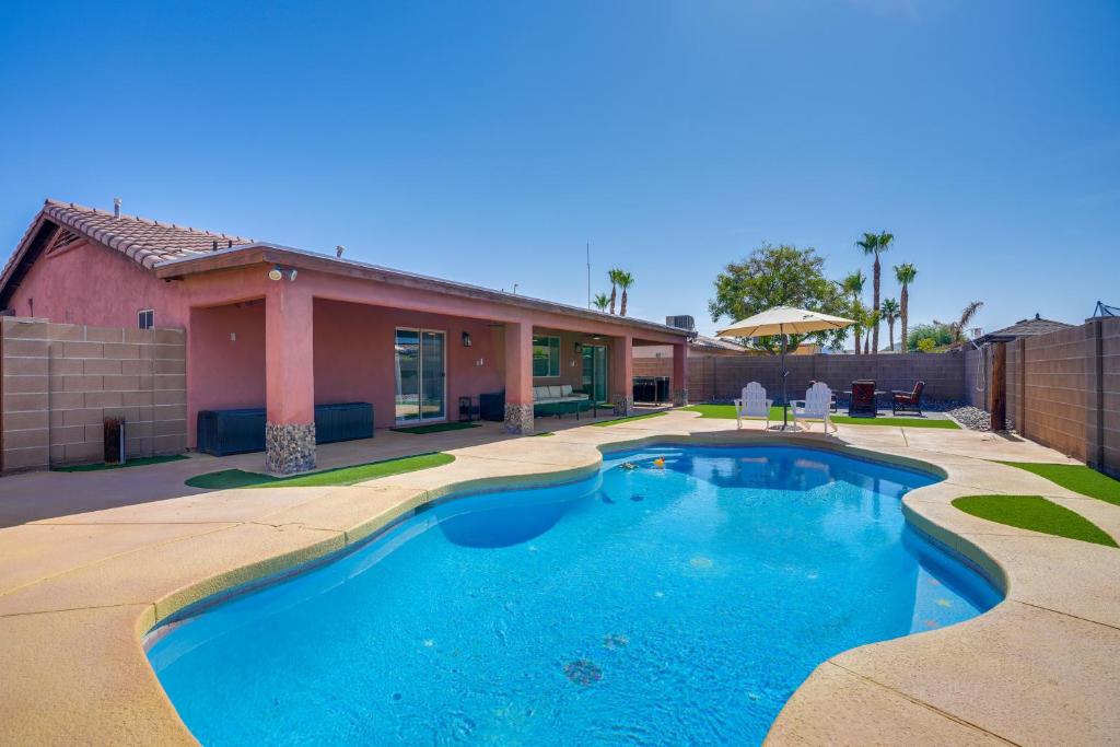 a swimming pool in front of a house at Near Golf Courses Poolside Paradise in Yuma! in Fortuna