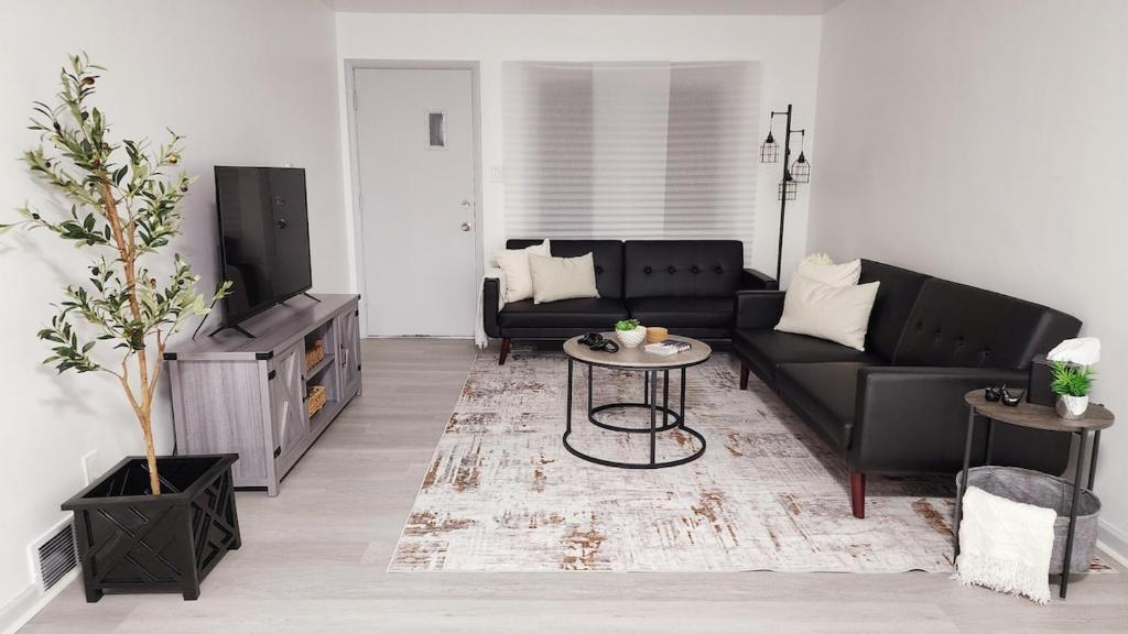 a living room with a couch and a table at Grand Manor - Big 2 Bedroom - USA Side in Niagara Falls