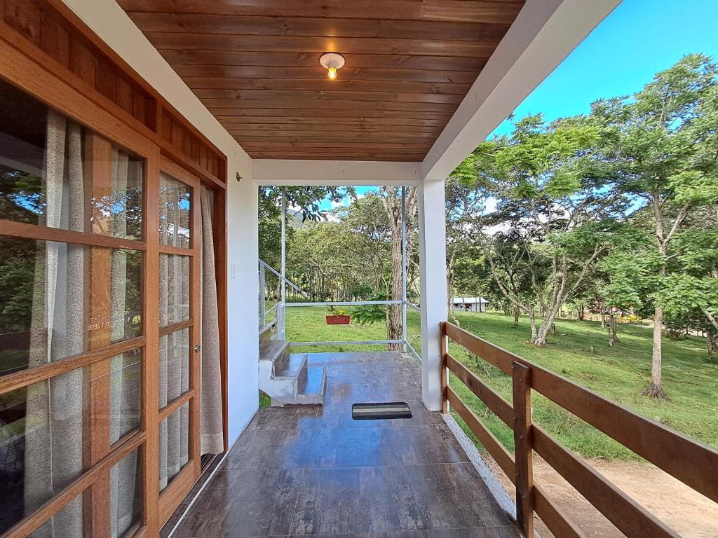 an empty porch of a house with a wooden door at Bellavista Hospedaje Vista asombrosa in Oxapampa