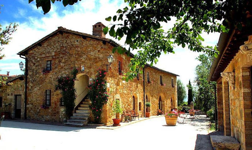 an old brick building with stairs and plants on it at SARNA Residence in San Quirico dʼOrcia