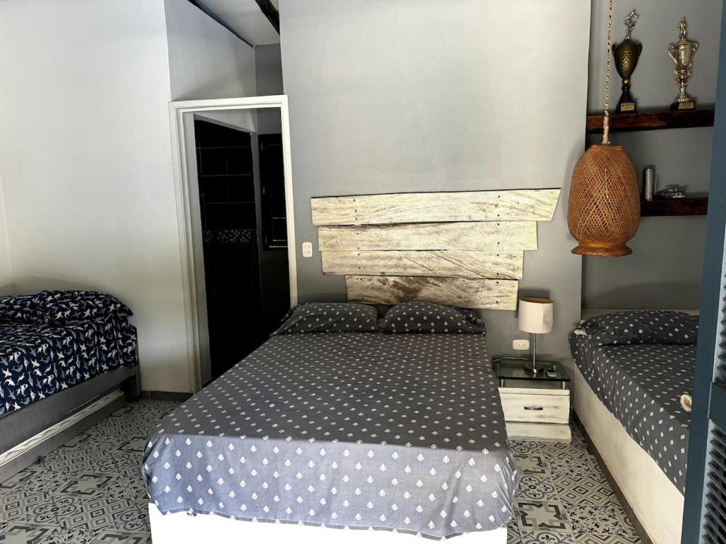 a bedroom with two beds and a mirror at Casa El Cielo in Piedecuesta