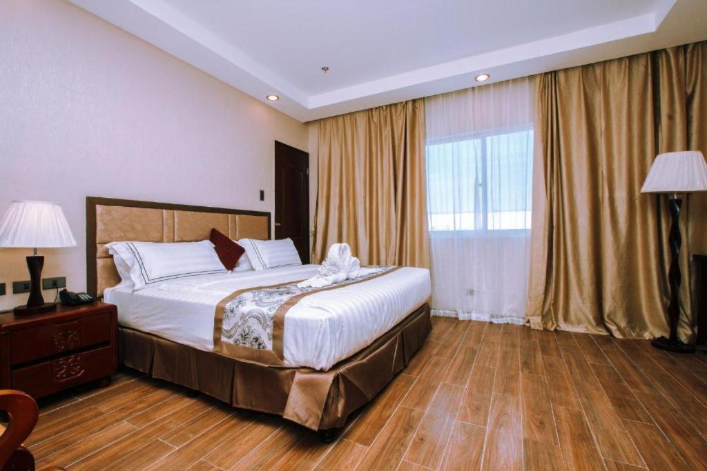 Postel nebo postele na pokoji v ubytování Palawan Uno Hotel