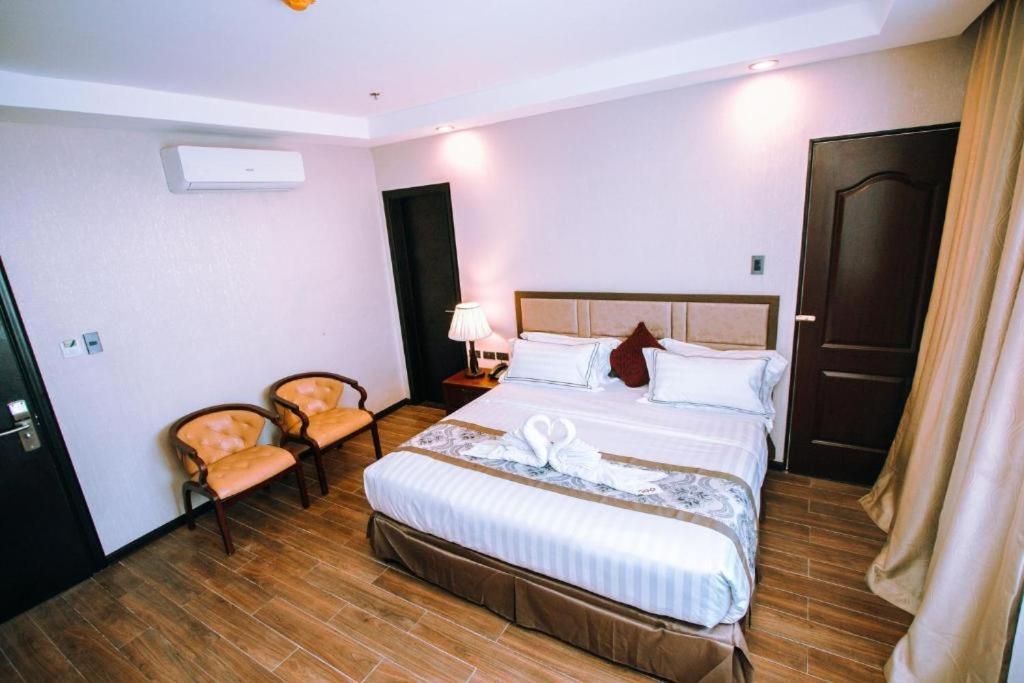Postel nebo postele na pokoji v ubytování Palawan Uno Hotel