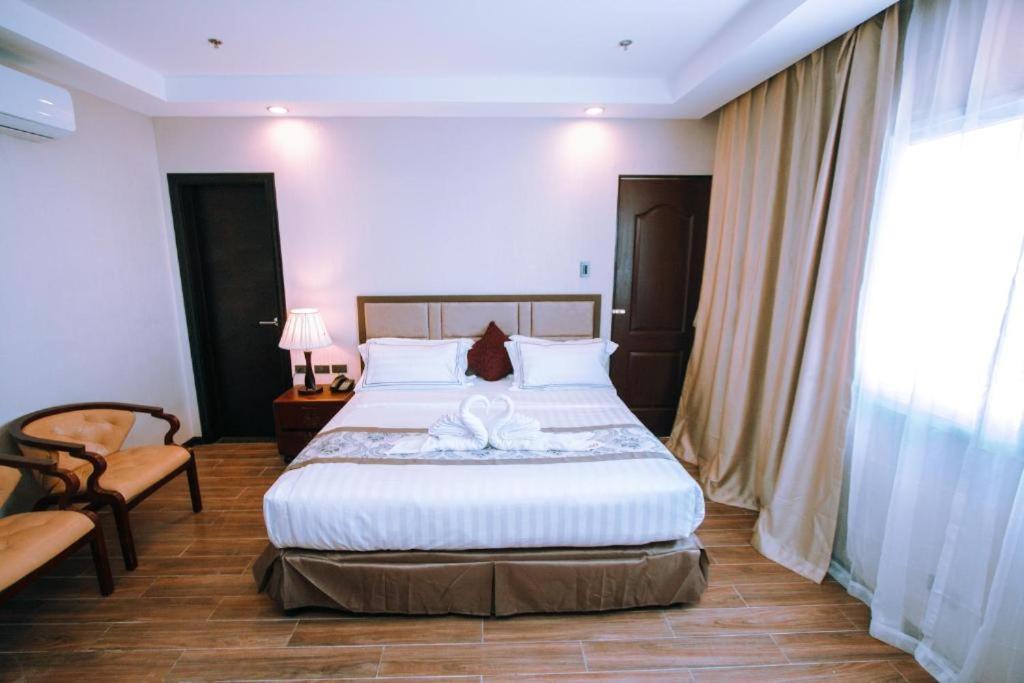 Postel nebo postele na pokoji v ubytování Palawan Uno Hotel
