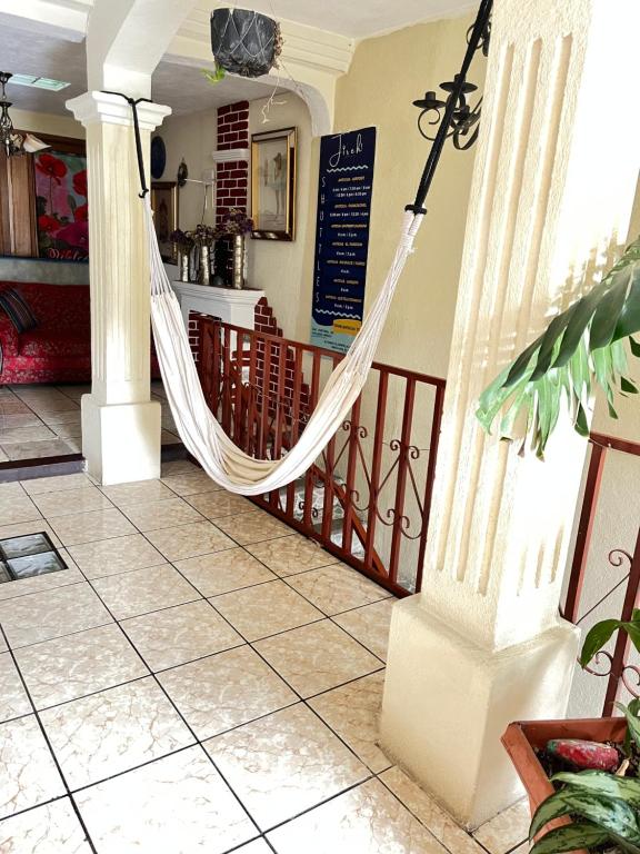 a porch with a hammock in a house at Jireh guesthouse in Antigua Guatemala