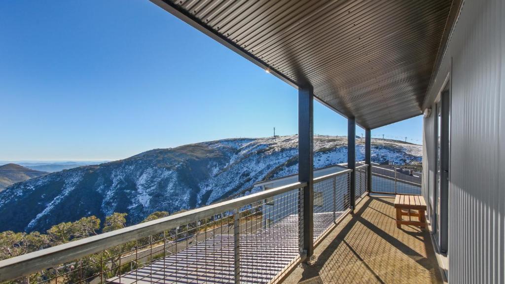 a balcony with a view of a snowy mountain at Alpine Heights 18 in Mount Hotham