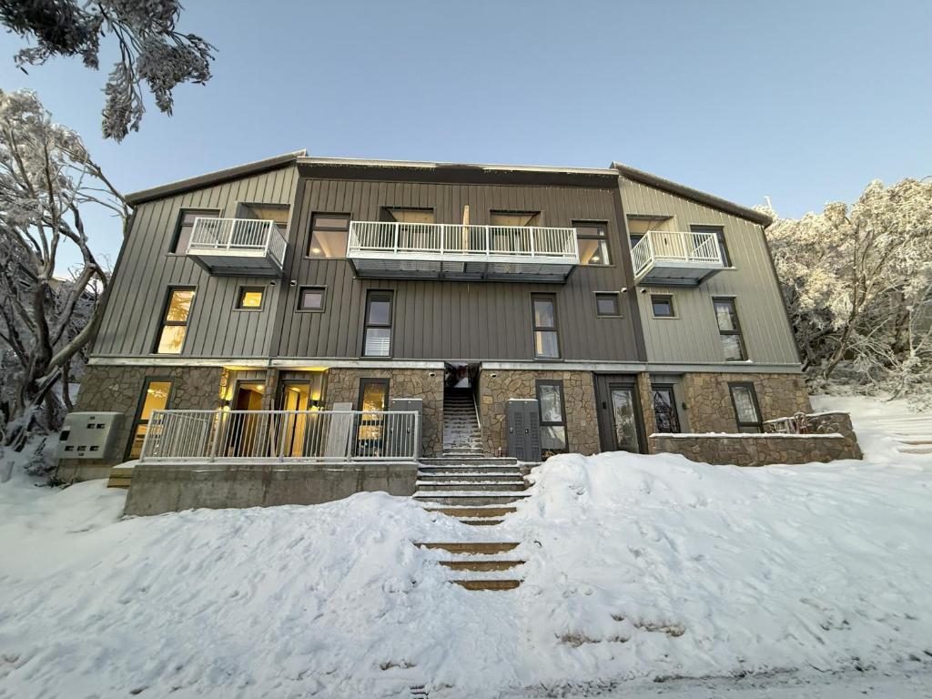 a large building with snow in front of it at Mt Buller 3BR Family Chalet-Spacious with Cozy Touches in Mount Buller