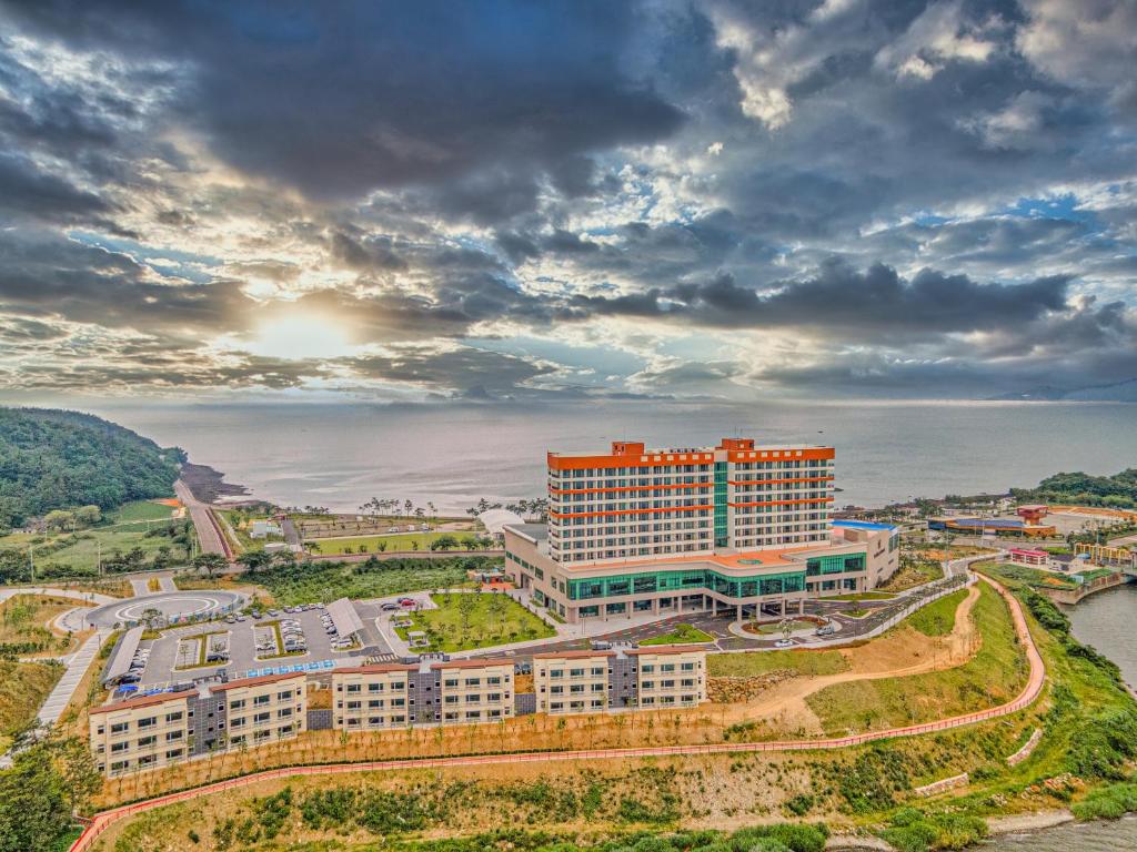 an aerial view of a building next to the water at Goheung Sun Valley Resort in Goheung