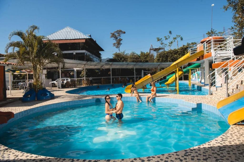 a group of people in the water at a water park at El Encanto de Las Marias in Satipo
