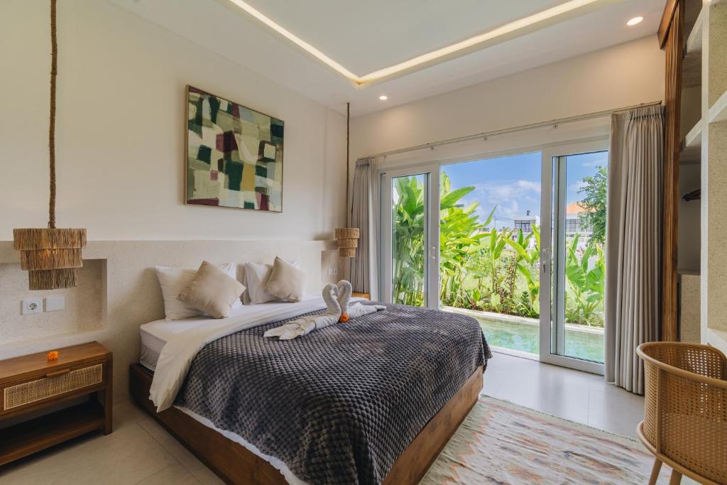 Ένα ή περισσότερα κρεβάτια σε δωμάτιο στο Villa Segara Angin