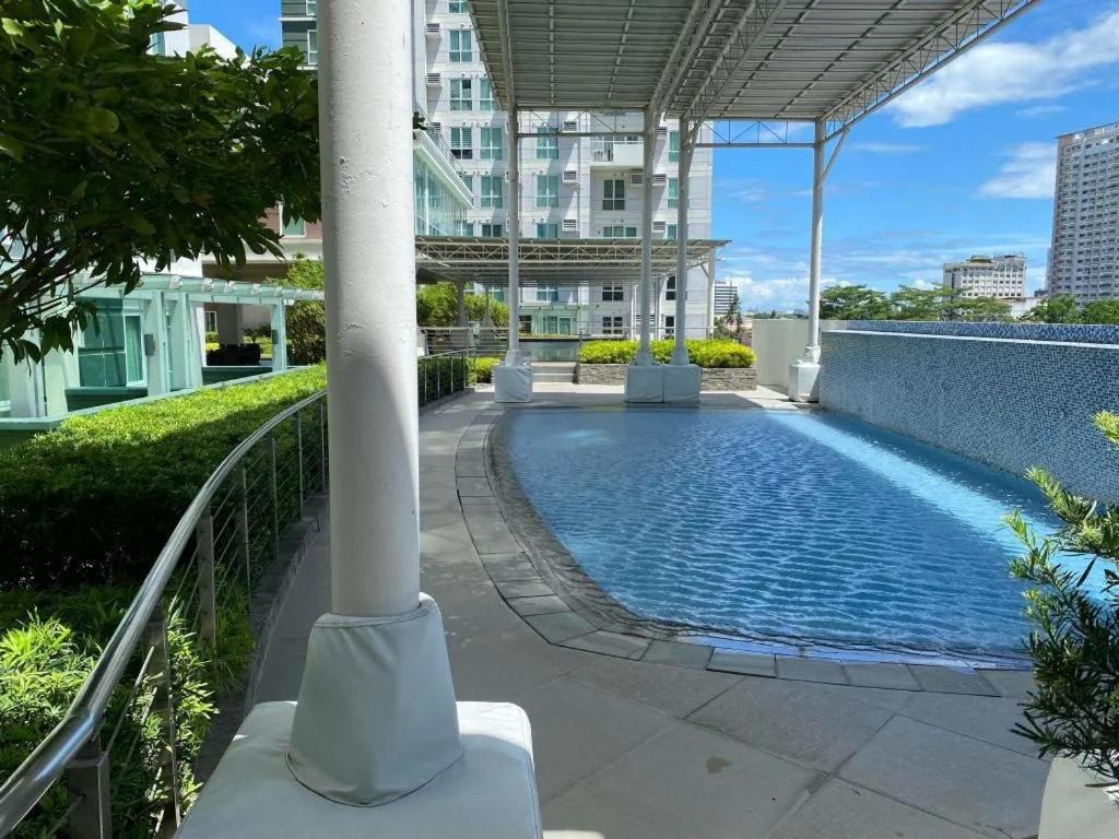 a swimming pool in the middle of a building at Davao Central Suites in Davao City