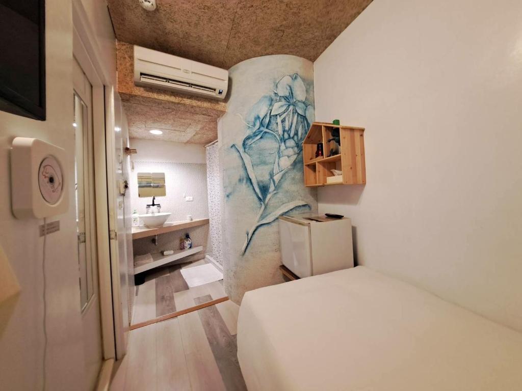 Postel nebo postele na pokoji v ubytování 墾丁橘月Orange Moon Inn