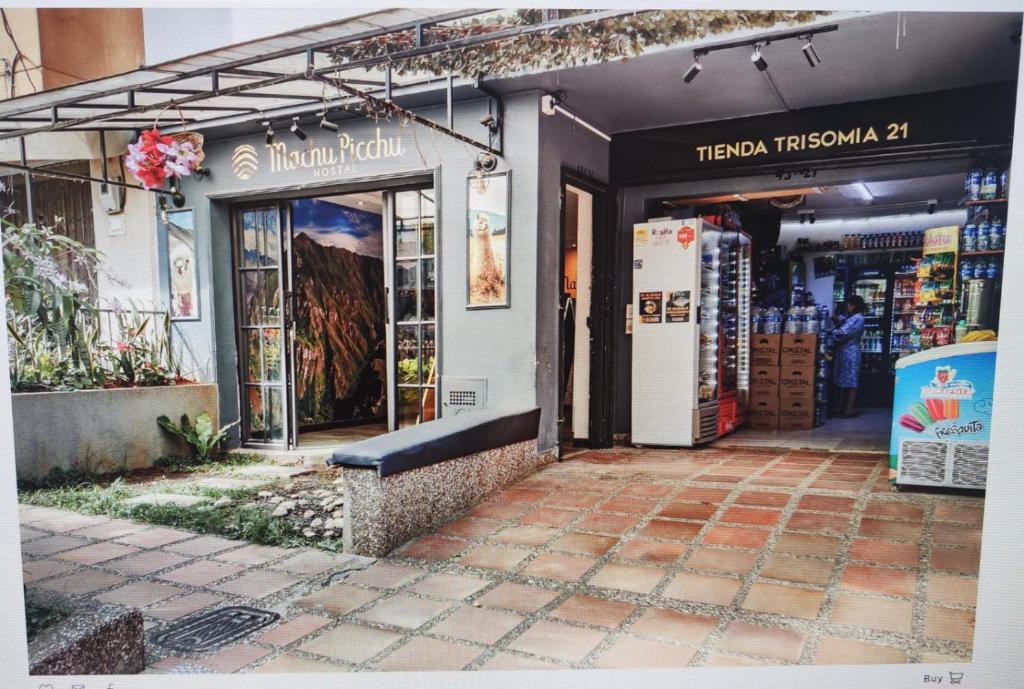 a store front with a bench in front of it at Hostal Machu Picchu Medellin in Medellín