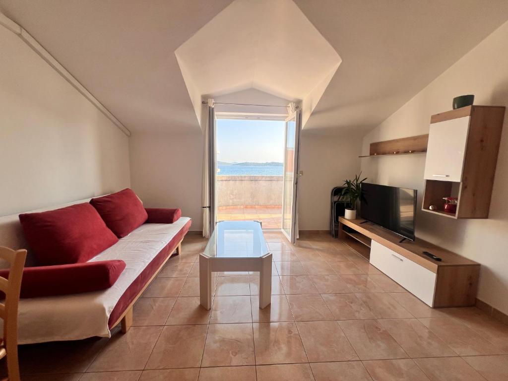 a living room with a couch and a tv at Apartment Danijela in Vodice
