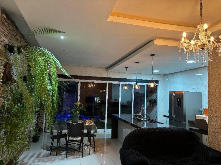 a living room with a kitchen and a dining room at Casa linda em Goianésia! in Goianésia